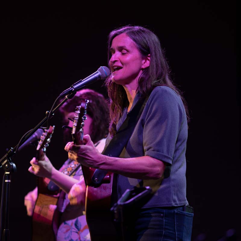 Woman playing a guitar during a worship service