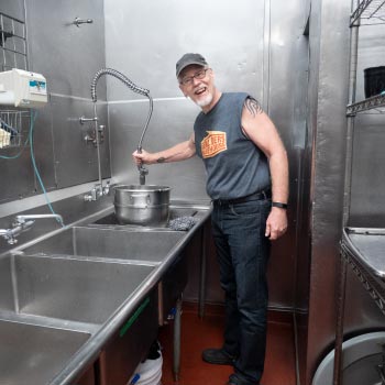 Person washing pots and pans