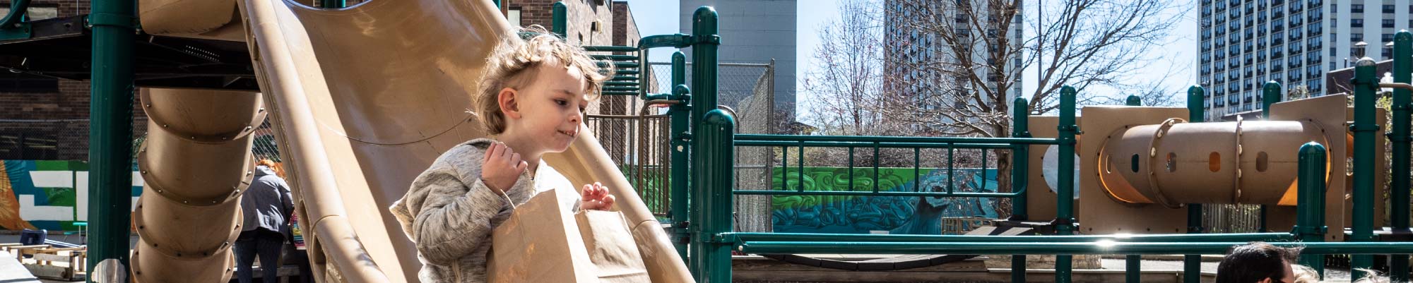 A child going down a slide in our playground