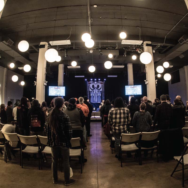 People standing during a worship service at Wilson Abbey